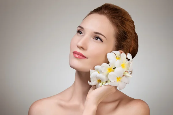 Kozmetikai arc, a gyönyörű, fiatal nő, virág. — Stock Fotó