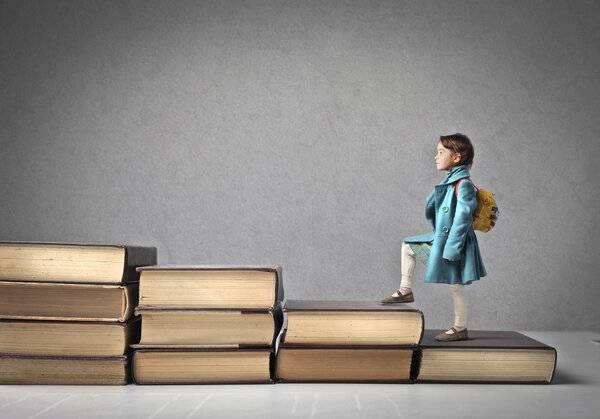 Baby Climbing a Ladder of Books