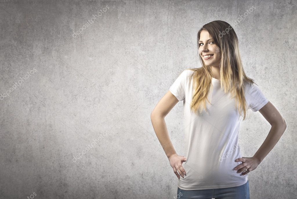 Young happy woman with a white t-shirt on a gray background