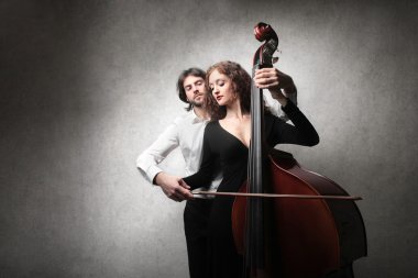 man, woman holding a double bass clipart