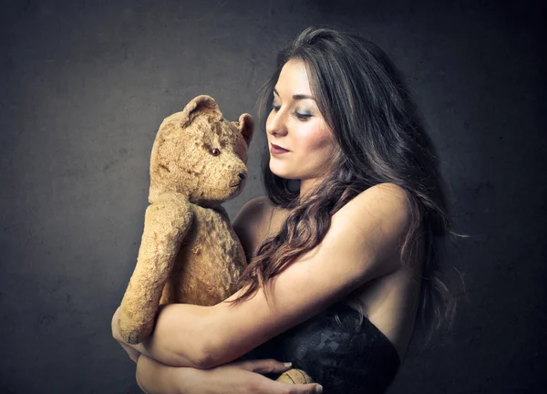 Woman holding a teddy bear Stock Image