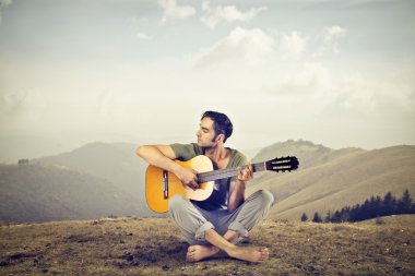 Man playing the guitar clipart