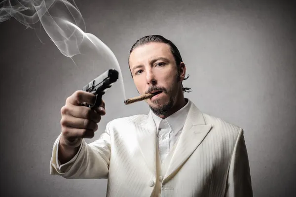 Rich man holding a gun — Stock Photo, Image