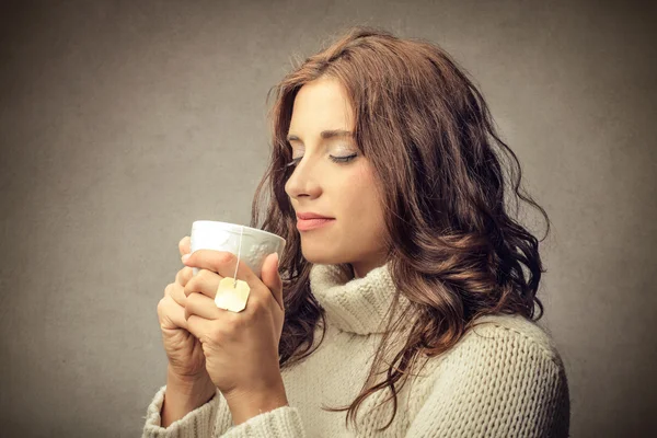 Woman about to drink a cup of tea — Stock Photo, Image