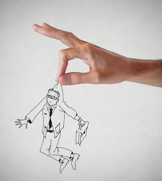 Hand som håller en affärsman — Stockfoto