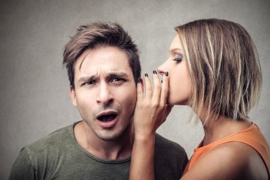 Woman telling a secret to a man clipart