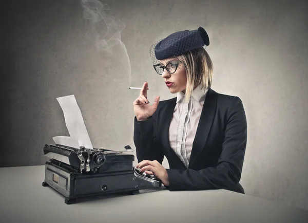 Woman typing and smoking Stock Photo