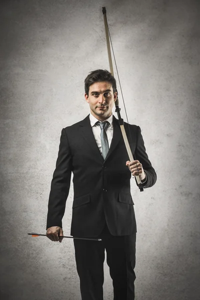 Businessman with bow and arrow — Stock Photo, Image