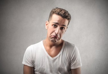 Üzgün genç adam ağlıyor.