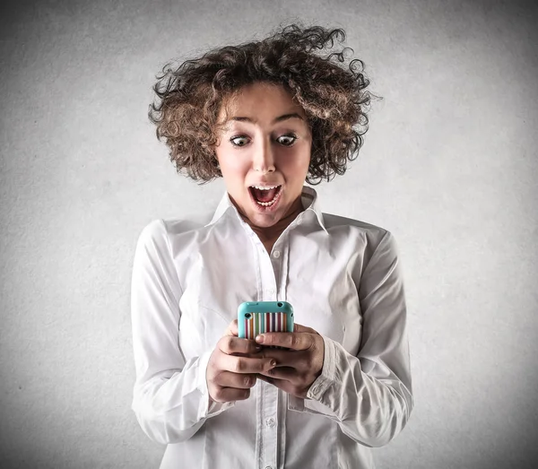 Surprised woman with a phone — Stock Photo, Image
