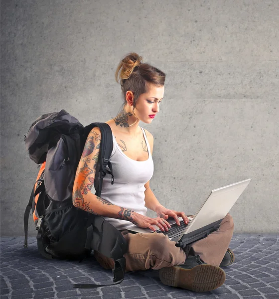 Backpacker kvinna med hennes laptop — Stockfoto