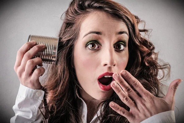 Atonished woman listening to something — Stock Photo, Image