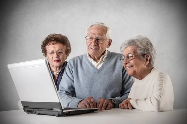 Old people looking at a laptop