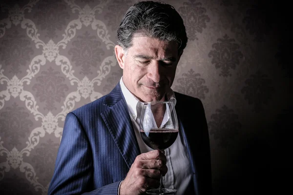 Elegant rich man with a glass of wine — Stock Photo, Image