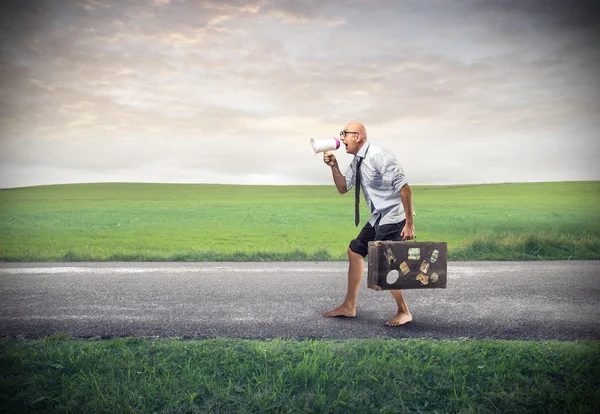 Poor businessman walking with his suitcase — Stock Photo, Image