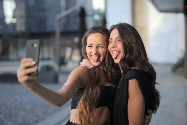 Two Friends Take Selfie Faces — стоковое фото