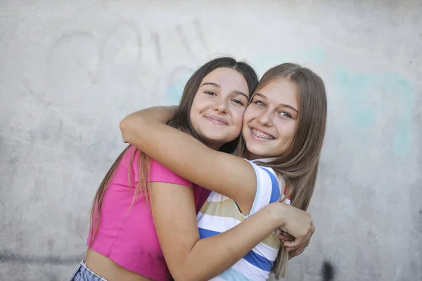 Two Young Girls Hugging Street — 스톡 사진