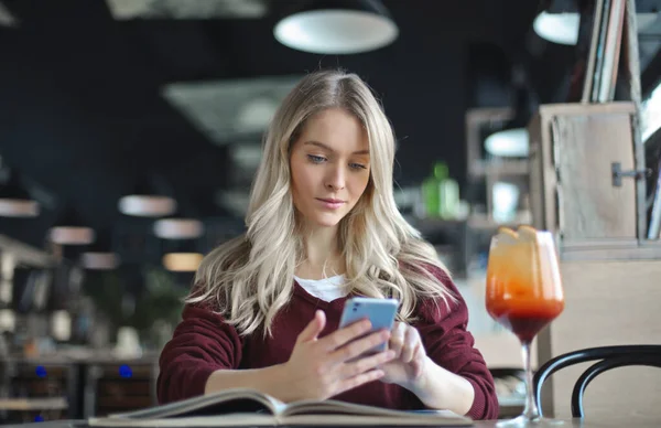 Genç Bir Kadın Bir Kafede Akıllı Telefon Kullanıyor — Stok fotoğraf