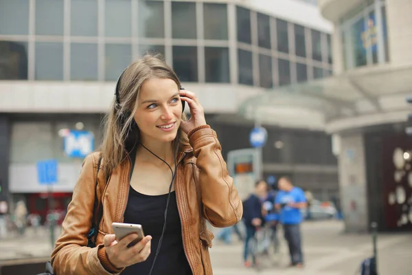 Young Woman Walks Street Listens Music — стоковое фото