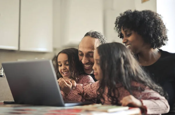 Family Smiles Front Laptop — стоковое фото