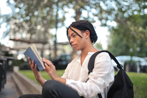 Young Man Reads Book Street —  Fotos de Stock