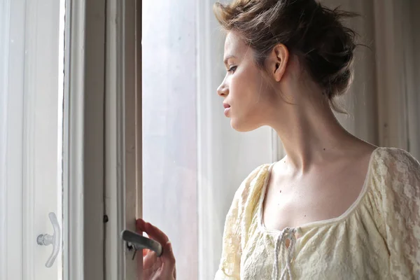 Young Woman Watches Window — Photo