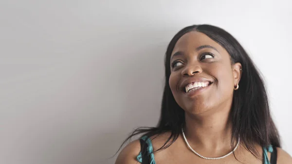 laughing young woman on gray background