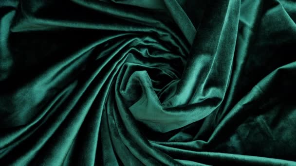 Elegantní měkký lesklý zelený sametový textil. Abstraktní móda, vnitřní textilie pozadí. Rotace.