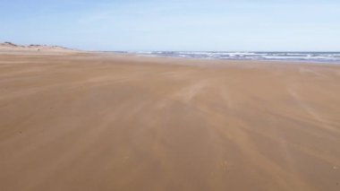 Essaouira, Fas 'ta sert rüzgarlı boş bir plaj sahnesi. Çevresel arka plan yavaş çekim 4K 'de. İklim değişikliği, aşırı hava.