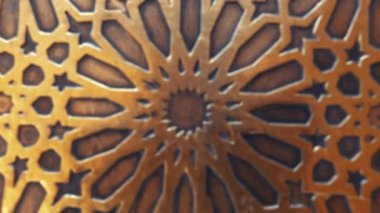 Traditional Moroccan Islamic geometric shape design in architecture. Golden door detail, architectural feature. Abstract background footage in 4k.