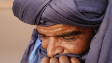 Closeup portrait of a Moroccan man wearing a turban. Authentic Bedouin of South Morocco. 4k.