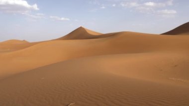Beautiful serene desert sand dunes landscapes in the Sahara desert, Mhamid, Erg Chigaga, Morocco. Panning, 4k. 
