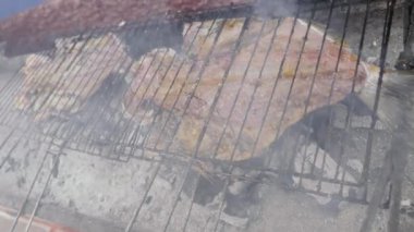 A dorade, gilt-head bream, sea bream fish is being grilled in a street restaurant in Morocco. Fresh seafood background, 4k footage.