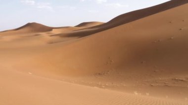 Beautiful serene desert sand dunes landscapes in the Sahara desert, Mhamid, Erg Chigaga, Morocco. Panning, 4k.