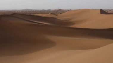 Beautiful serene desert sand dunes landscapes in the Sahara desert, Mhamid, Erg Chigaga, Morocco. Panning, 4k.