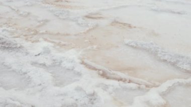 Natural sea salt extraction, evaporation ponds, at the Tazgha salt flats in South Morocco, Atlantic ocean sea salt. Nature abstract background footage in 4k.