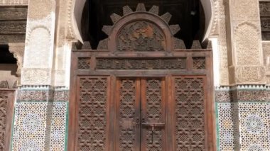 Fez, Morocco - July 24, 2022: Interior architecture of the Madrasa (medersa) Bou Inania, a koranic school, with mosque, in the Medina of Fez (Fes), Morocco. Landmark and important travel destination of Fes. 4k footage.