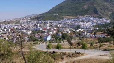 View of the blue city Chefchaouen, in Morocco, including the new town and the medina. Famous touristic travel destination because of its blue painted houses. 4k, establishing shot.