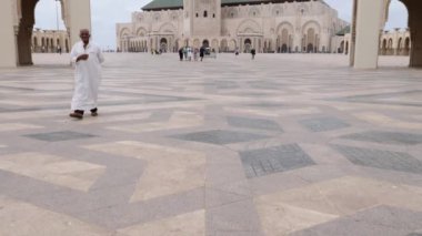 Casablanca, Morocco - July 29, 2022: Moslems come out of the Mosque Hassan II after the Friday prayer. 4k footage