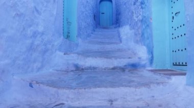 Street detail with blue painted house in Chefchaouen, Morocco. The Medina of Chefchaouen is a famous touristic travel destination. 4k footage.