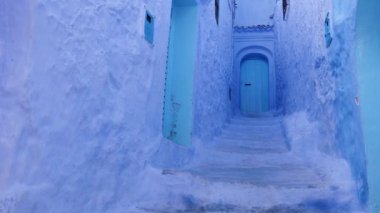 Street detail with blue painted house in Chefchaouen, Morocco. The Medina of Chefchaouen is a famous touristic travel destination. 4k footage.