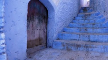 Street detail with blue painted house in Chefchaouen, Morocco. The Medina of Chefchaouen is a famous touristic travel destination. 4k footage.