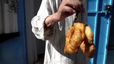 Freshly fried Moroccan doughnuts from a street restaurant in Chefchaouen. Popular, traditional breakfast in Chefchaouen, North Morocco. Food background footage. 4k
