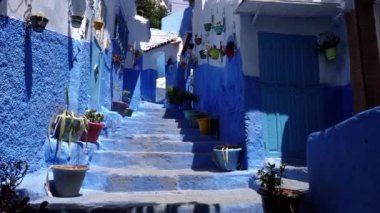Street detail with blue painted house in Chefchaouen, Morocco. The Medina of Chefchaouen is a famous touristic travel destination. 4k footage.