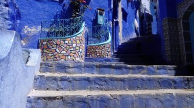 Street detail with blue painted house in Chefchaouen, Morocco. The Medina of Chefchaouen is a famous touristic travel destination. 4k footage.