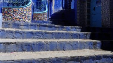 Street detail with blue painted house in Chefchaouen, Morocco. The Medina of Chefchaouen is a famous touristic travel destination. 4k footage.