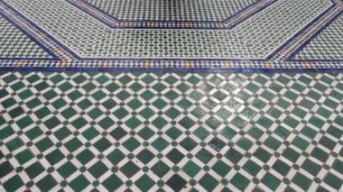 Colorful zellige floor tiles in mosaic pattern, traditional Islamic geometric design of a fountain in Marrakech, Morocco. Moroccan craft, handmade with natural colors from indigo, saffron, mint, kohl. 4k