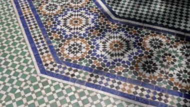 Colorful zellige floor tiles in mosaic pattern, traditional Islamic geometric design of a fountain in Marrakech, Morocco. Moroccan craft, handmade with natural colors from indigo, saffron, mint, kohl. 4k