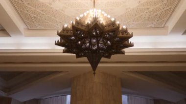 A big Moroccan, Arabic golden brass lamp with intricate pattern. Luxury lifestyle, interior background footage. 4k
