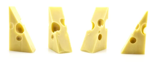 Varios trozos de queso con agujeros sobre un fondo blanco . — Foto de Stock